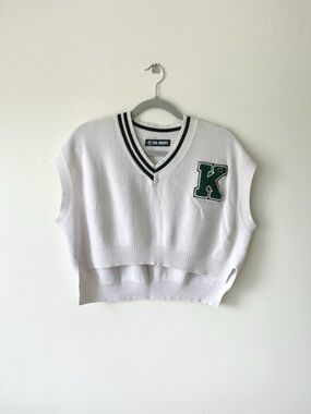 The Kript White Knit V-Neck Cropped Varsity Sweater Vest with Green 'K' Patch